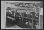 [Factory workers on assembly line for bearings]